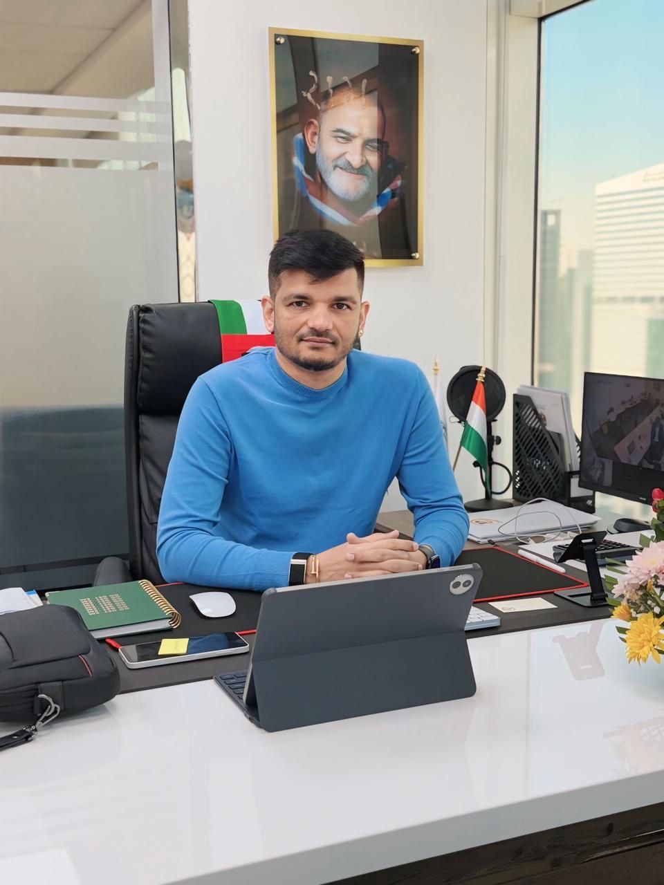 Priteesh Patel working at a modern office desk