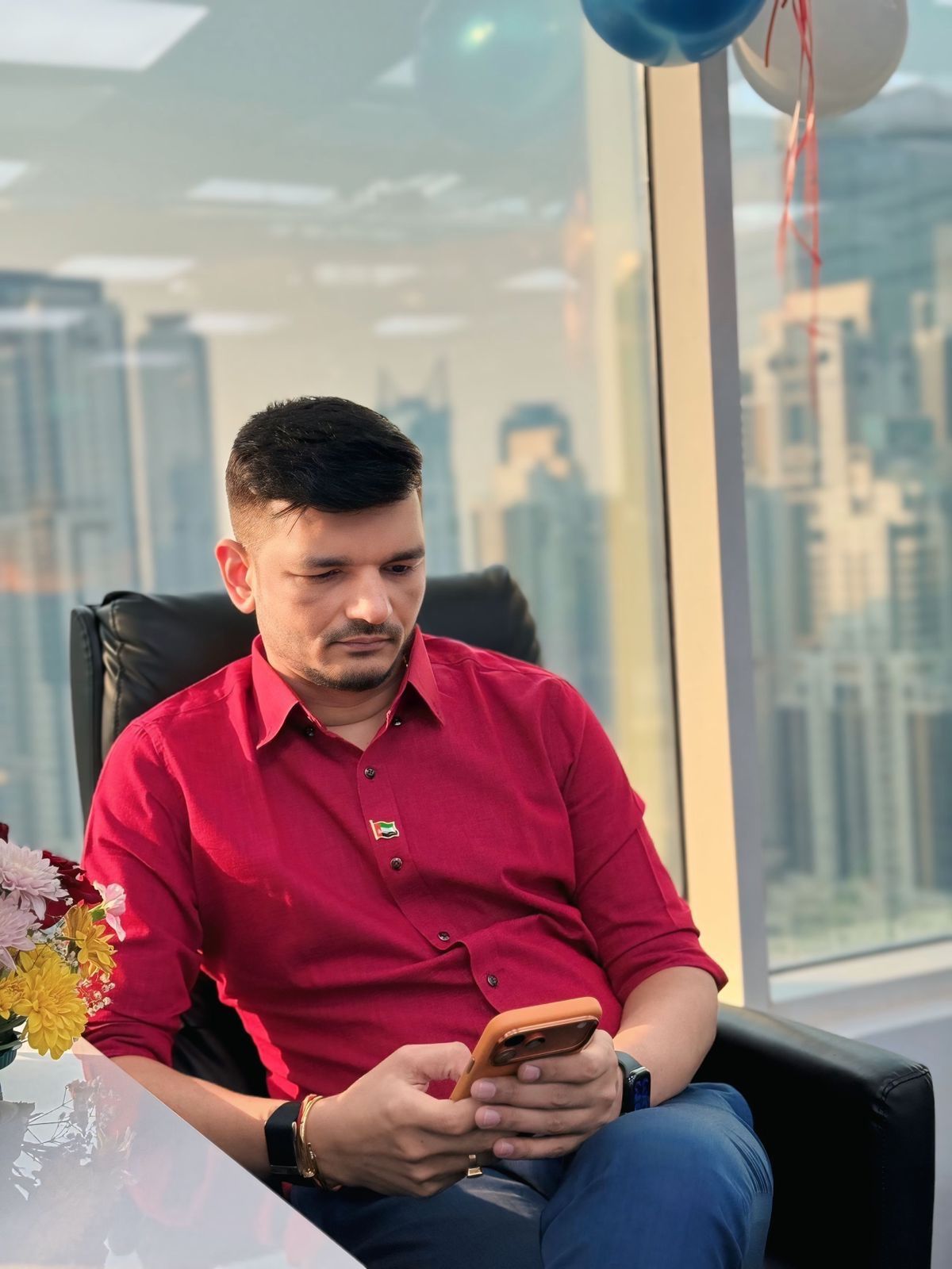 Priteesh Patel using his phone in an office lounge